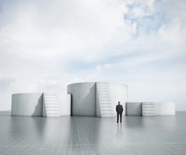 Businessman looking at empty podiums — Stock Photo, Image