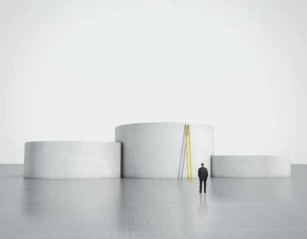 Businessman looking at empty podiums — Stock Photo, Image