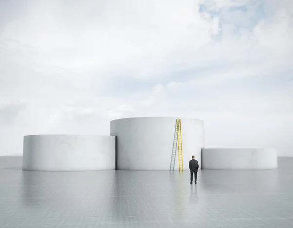 Businessman looking at empty podiums — Stock Photo, Image