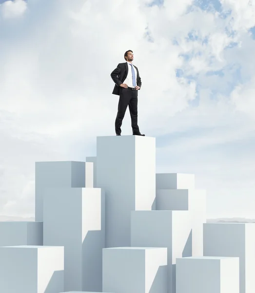 Man standing on highest cube — Stock Photo, Image