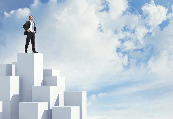 Man standing on highest cube — Stock Photo, Image