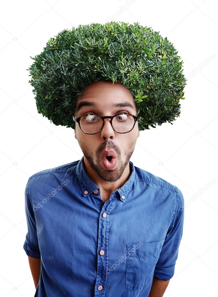 Young cross-eyed man with green bush