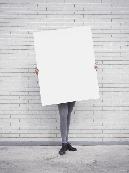 Girl holding blank poster — Stock Photo, Image