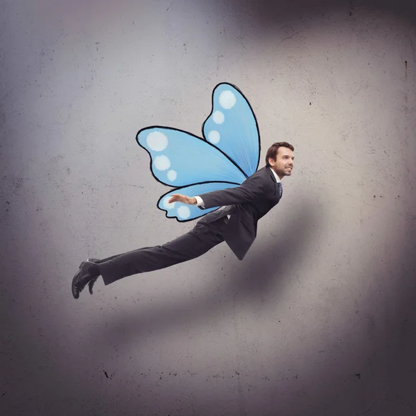 Businessman flying like butterfly — Stock Photo, Image