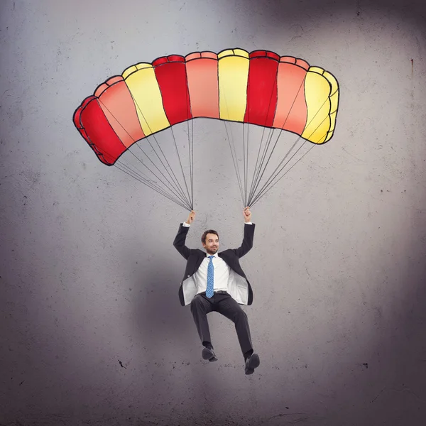 Businessman with parachute — Stock Photo, Image