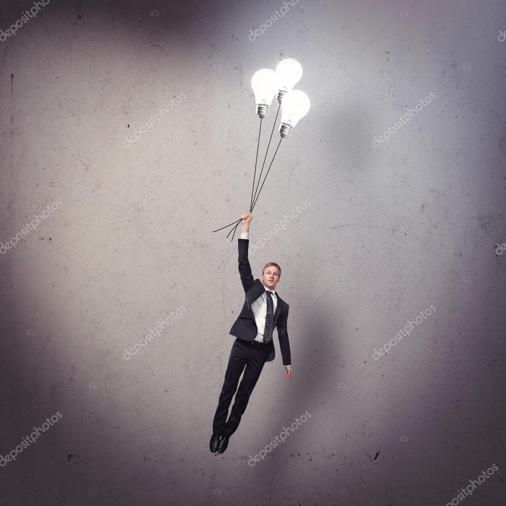 Businessman flying with light bulbs — Stock Photo © kantver 42289619