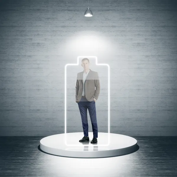 Businessman standing in office in light frame — Stock Photo, Image