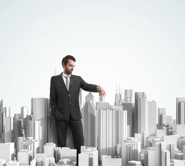 Businessman and model of a city — Stock Photo, Image