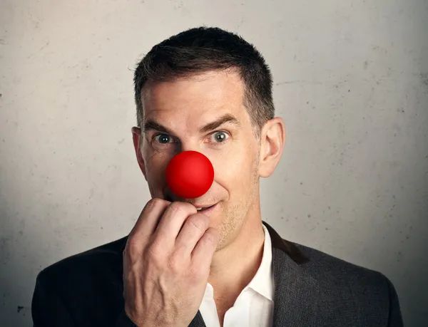 Businessman with red nose — Stock Photo, Image