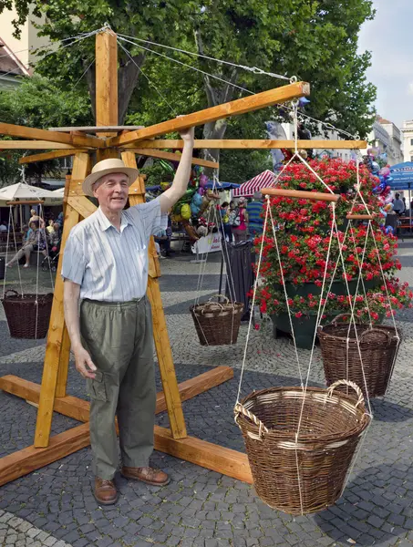 Senior with traditional woody childrens carousel — Stock Photo, Image