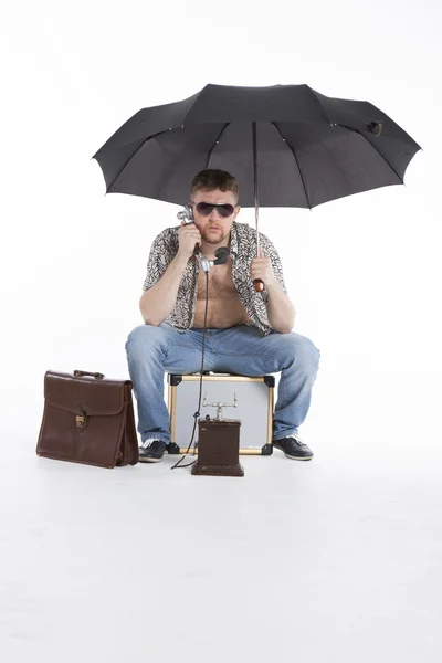 Young athletic businessman under umbrella — Stock Photo, Image