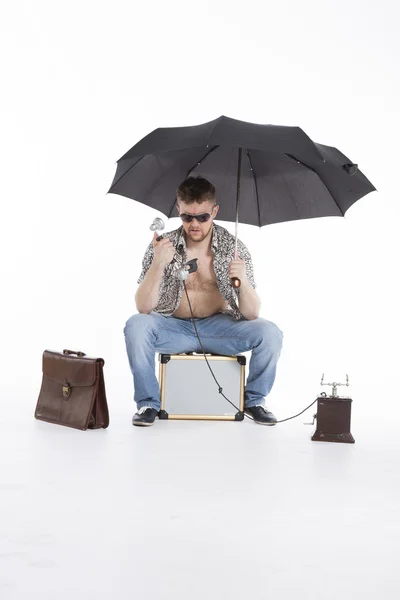 Young athletic businessman under umbrella — Stock Photo, Image