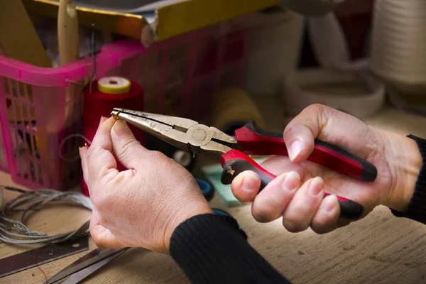 Woman working with pliers — Stock Photo, Image