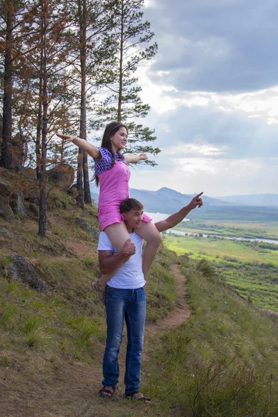 Young man holding the girl on a neck — Stock Photo, Image