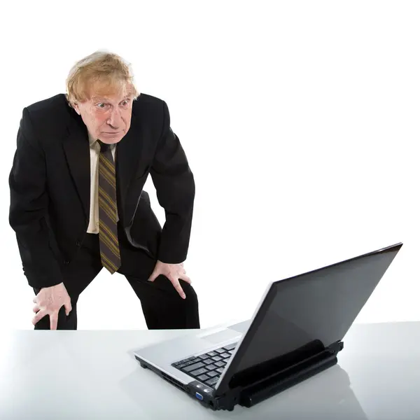 Businessman amazedly shows on laptop — Stock Photo, Image