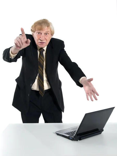 Businessman amazedly shows on laptop — Stock Photo, Image