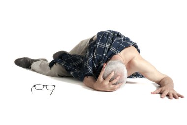 Upset man covered with blanket lying on on the floor
