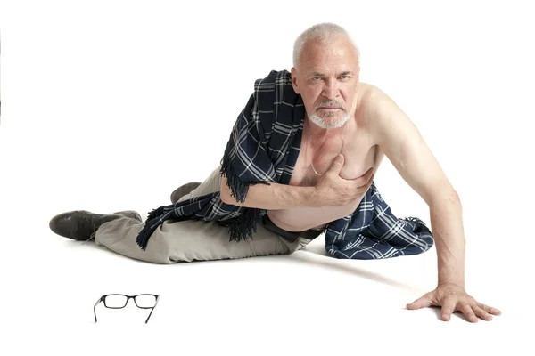 Upset man lying on the floor and holds the heart — Stock Photo, Image