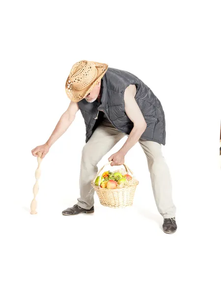 Man with a basket of fruit and cane — Stock Photo, Image