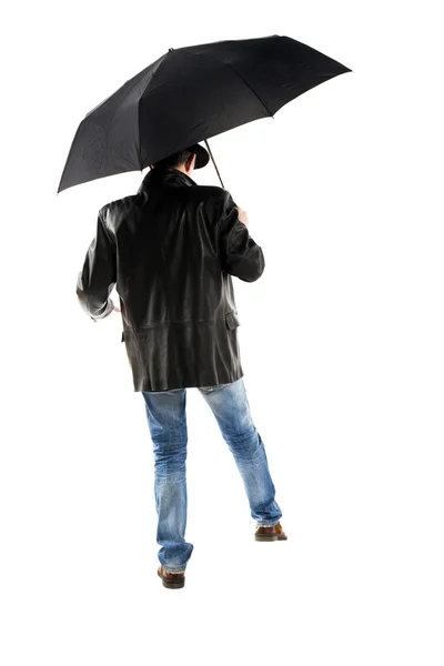 Homem com guarda-chuva preto andando sobre um fundo branco — Fotografia de Stock