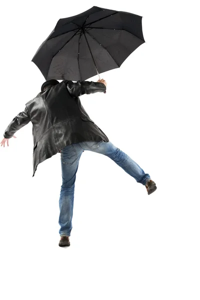 Homem com guarda-chuva preto andando sobre um fundo branco — Fotografia de Stock