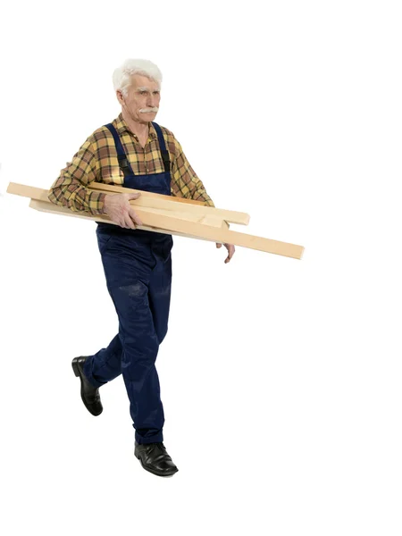 Construtor com um pedaço de madeira — Fotografia de Stock