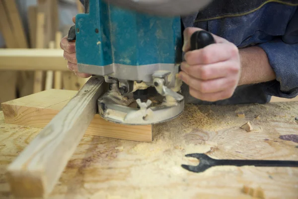 Man met router op plank van hout — Stockfoto