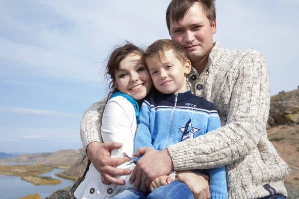 Happy family on the mountain with lake — Stock Photo, Image