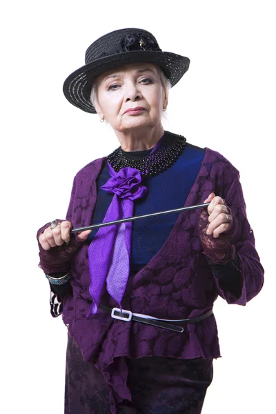 Elderly woman in a hat with a pointer — Stock Photo, Image