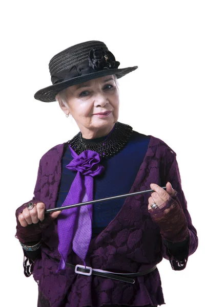 Elderly woman in a hat with a pointer — Stock Photo, Image