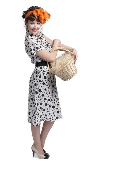 Young girl holding a basket with hay — Stock Photo, Image