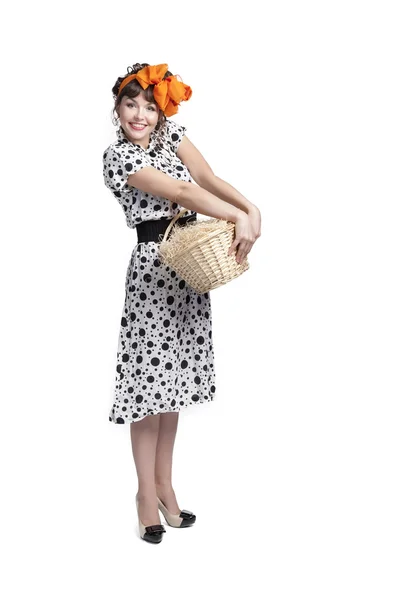 Young girl holding a basket with hay — Stock Photo, Image