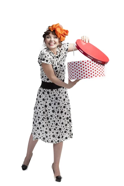 Happy girl opening gift box with red polka dots — Stock Photo, Image