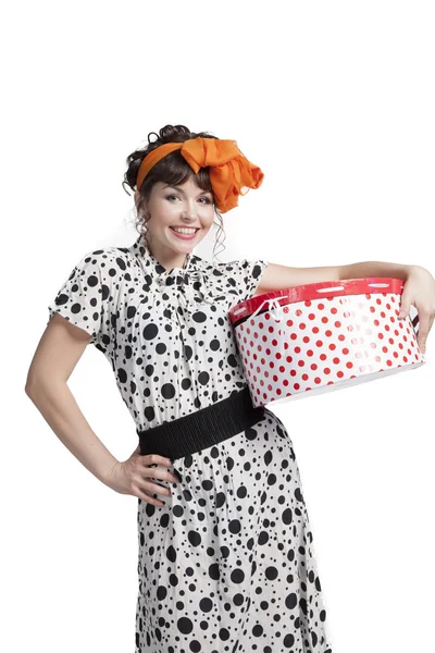 Happy girl holding gift box with red polka dots — Stock Photo, Image