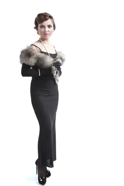 Woman wearing a black dress, fur and beads — Stock Photo, Image