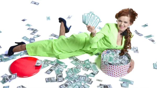 Happy woman lying  with money in a box — Stock Photo, Image