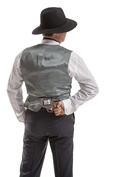 Man holding a gun behind his back — Stock Photo, Image