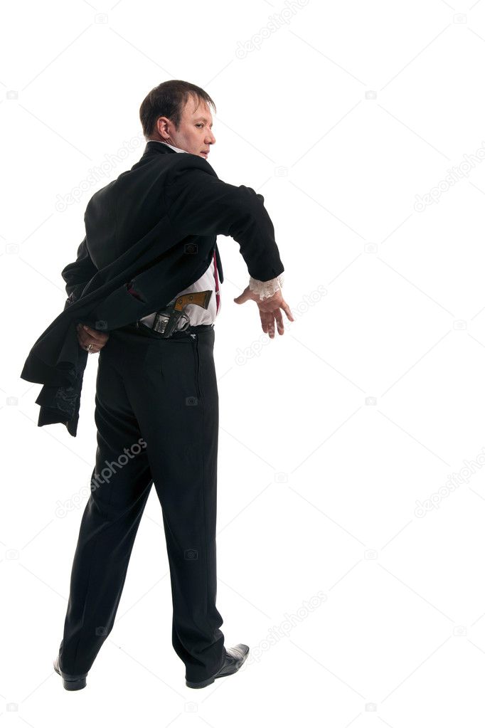 Man holding a gun behind his back