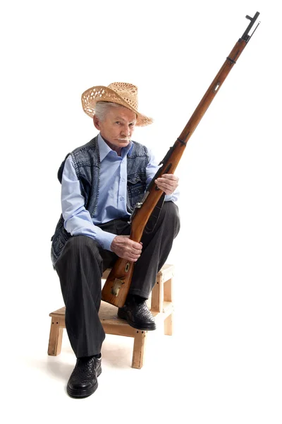 총을 들고 앉아 모자 남자 — 스톡 사진