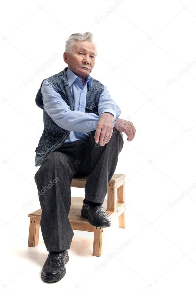 Elderly man sitting on the on wooden stairs