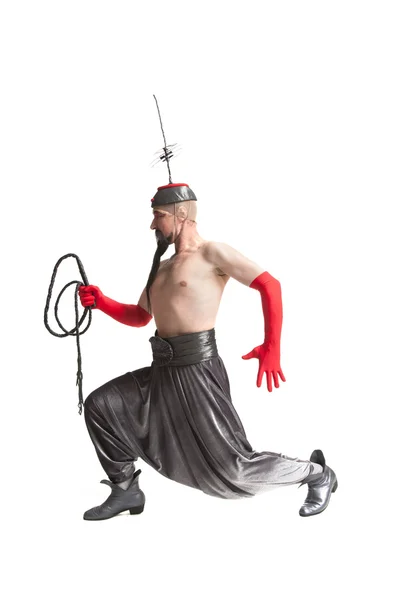 Man in a costume with a whip — Stock Photo, Image