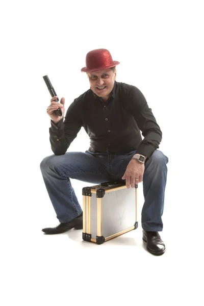 Man with a pistol sitting on the case — Stock Photo, Image