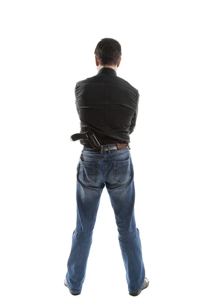Человек с пистолетом за спиной — стоковое фото