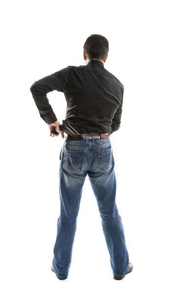 Man with a gun behind his back — Stock Photo, Image