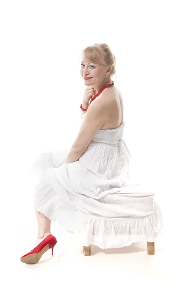 Blonde in white dress and red shoes — Stock Photo, Image