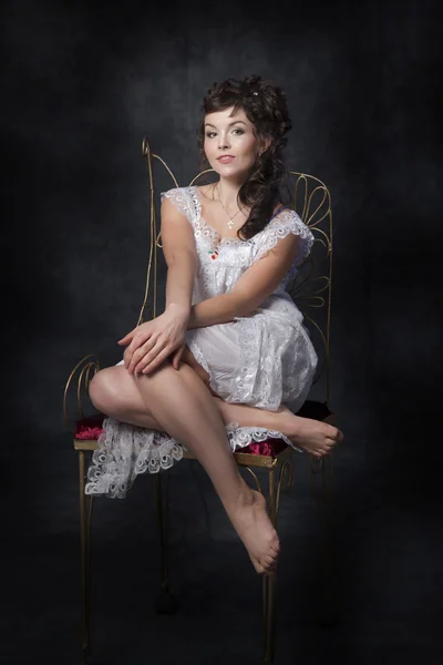 Woman on vintage chair — Stock Photo, Image