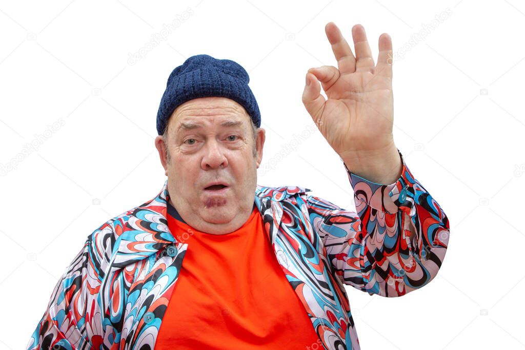 A cheerful and extravagant grandfather in a sports cap entertains, laughs and shows an o kay gesture!