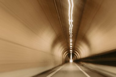 Abstract speed motion in road tunnel. Blurred motion and point-of-view driving on empty road. Photo taken in San Francisco, California, United States