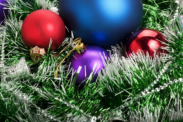 Christmas balls in green garland with Christmas bells — Stock Photo, Image