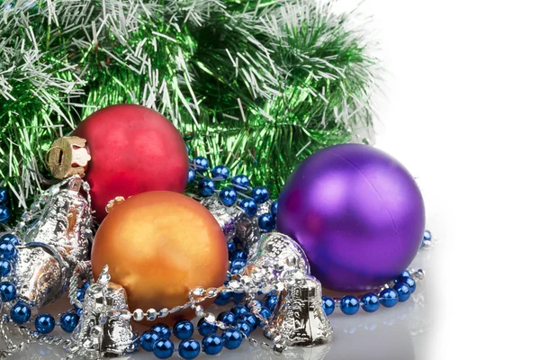 Three Christmas balls with blue beads, green garland and silver — Stock Photo, Image